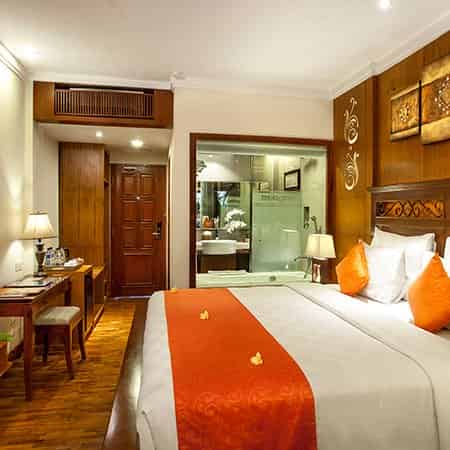 Warm wooden interior of a bedroom at Astagina Resort.