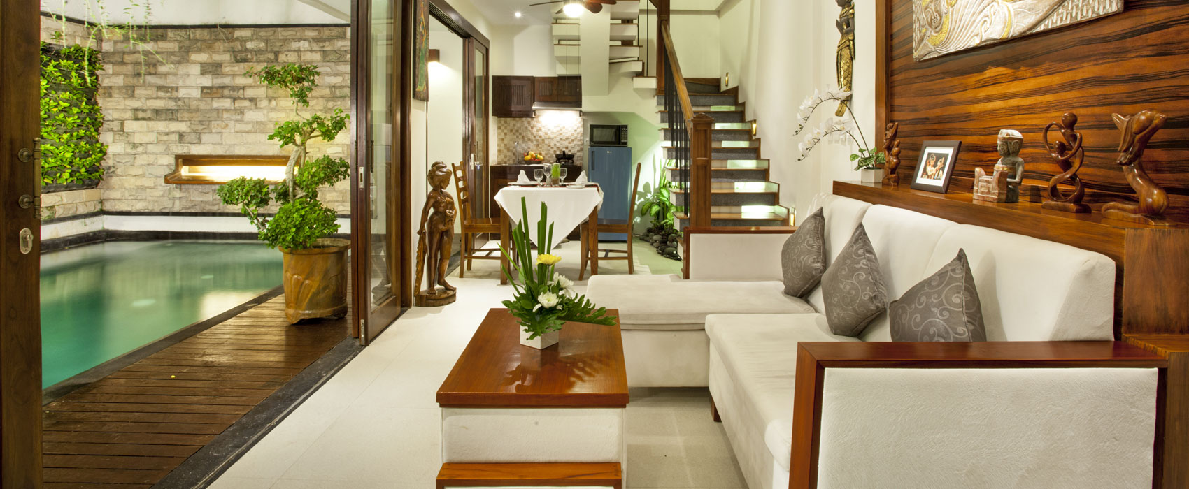 Living room of a 1-bedroom pool villa at Astagina Resort with direct pool access.