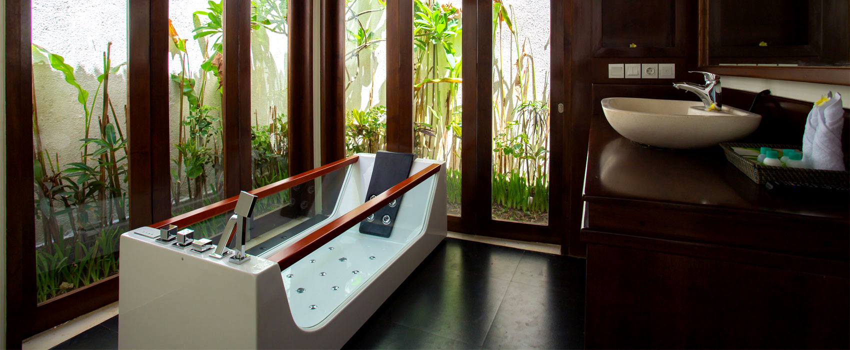 Modern ensuite bathroom at Samboga Pool Villa featuring a white vessel sink and wooden vanity.
