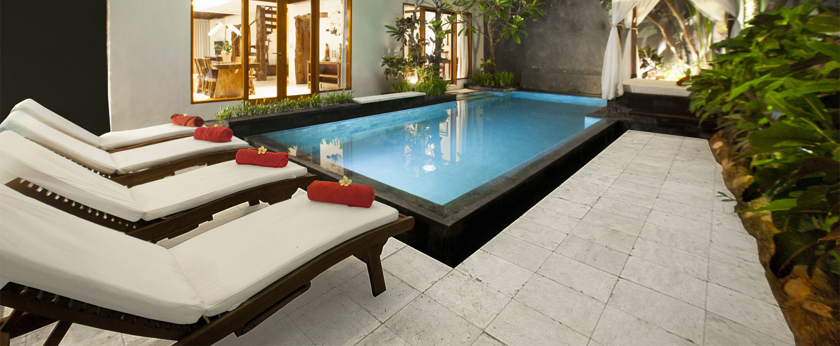 Private swimming pool at Kanaka Three Bedroom Royal Pool Villa with sun loungers.