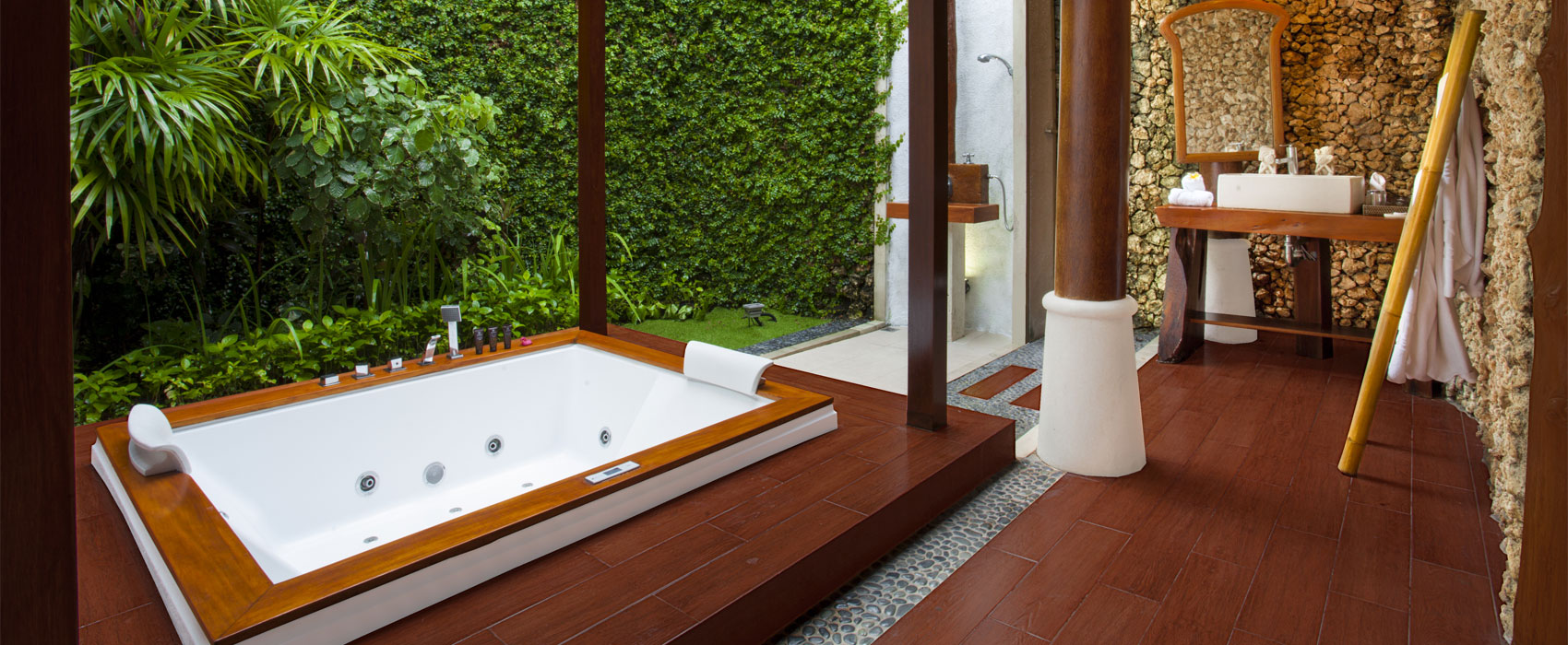 Luxury semi-outdoor bathroom at Kanaka Royal Pool Villa with a large whirlpool bathtub.