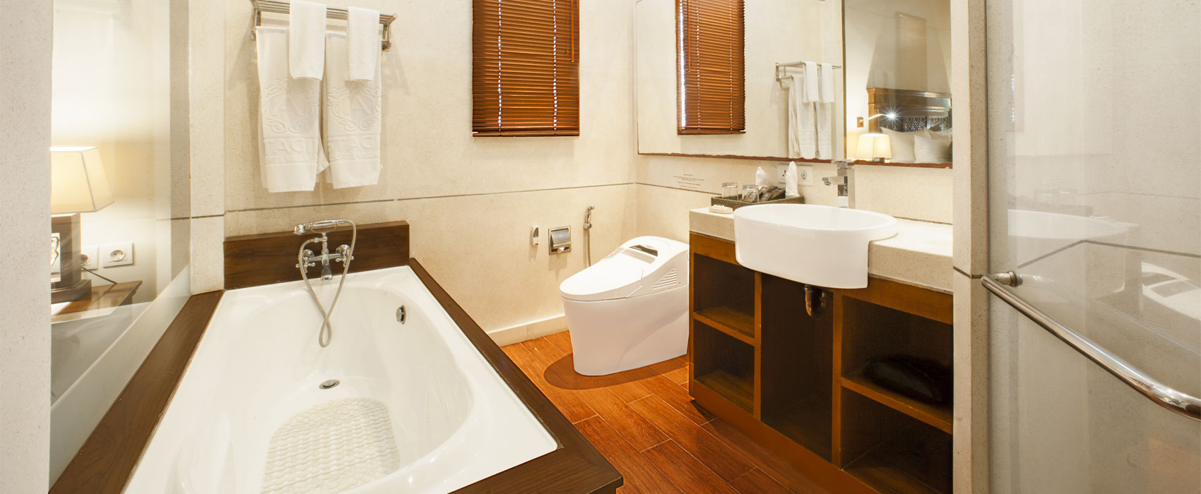 Modern ensuite bathroom in Arana Two Bedroom Garden Villa with a white soaking tub.
