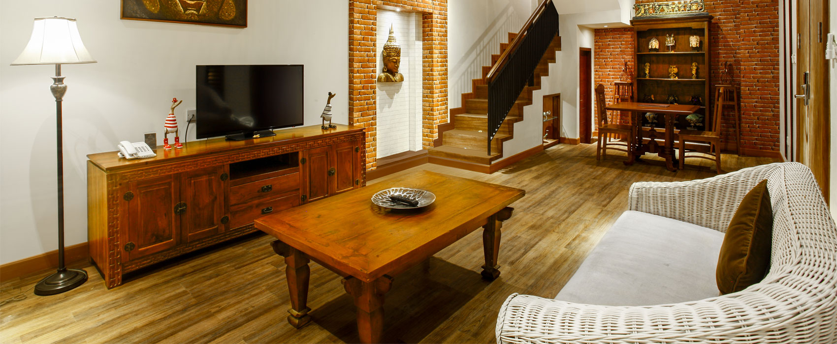 Elegant living room of Purana Temple Villa at Astagina Resort with traditional Balinese decor.