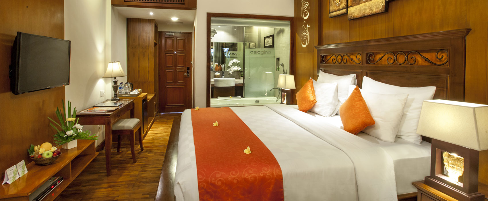 Elegant bedroom in a Deluxe Terrace room at Astagina Resort with a king-size bed.
