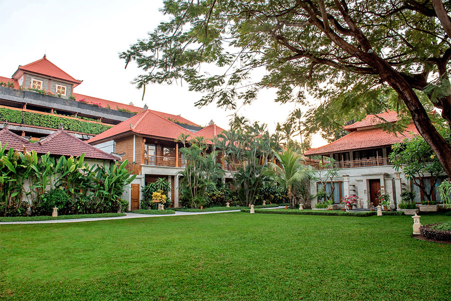 A wide-angle view of the manicured main garden at Astagina Resort