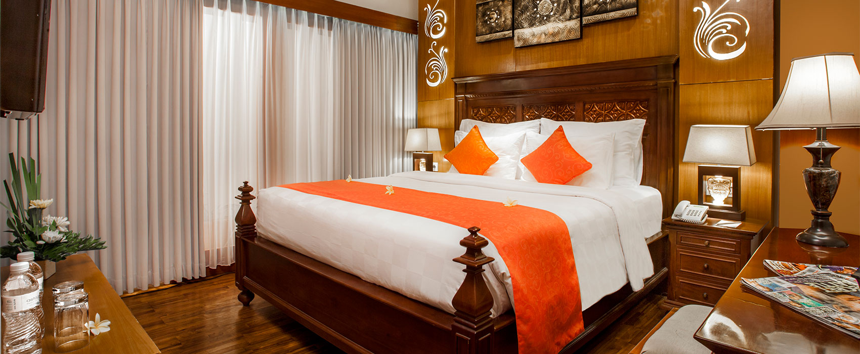 Elegant master bedroom of a Two Bedroom Suite at Astagina Resort with orange accents.