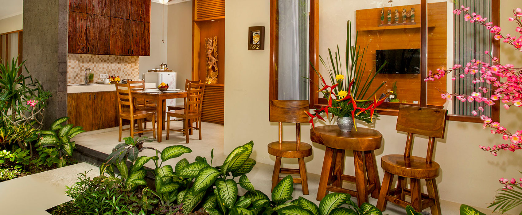 Private terrace of a 2-bedroom suite at Astagina Resort with wooden dining furniture.