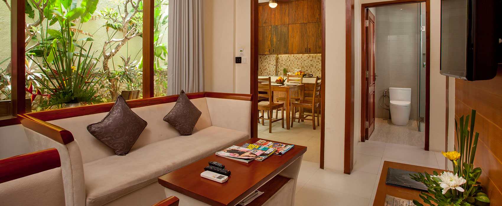 Spacious living and dining area in a luxury suite at Astagina Resort with garden views.