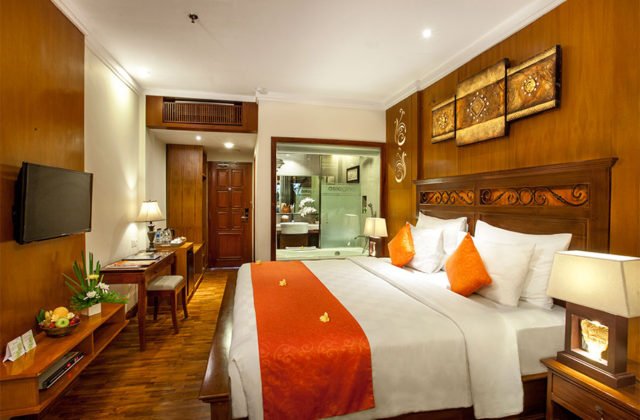 Private wooden balcony of the Deluxe Terrace room overlooking the tropical garden at Astagina Resort.