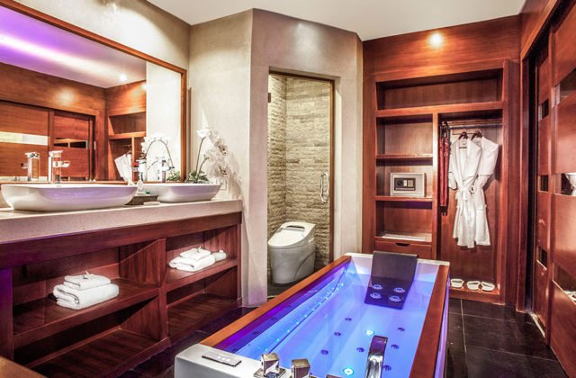 Luxury Suite bathroom featuring an elegant bathtub setup and pristine amenities at Astagina Resort Bali.