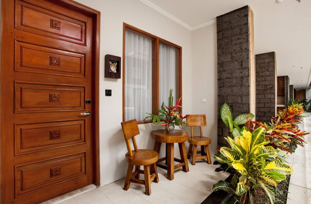 Private room balcony with cozy seating area for outdoor relaxation at Astagina Resort.