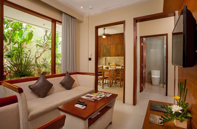 Open-plan villa living space with direct access to the connecting dining area and en-suite bathroom.