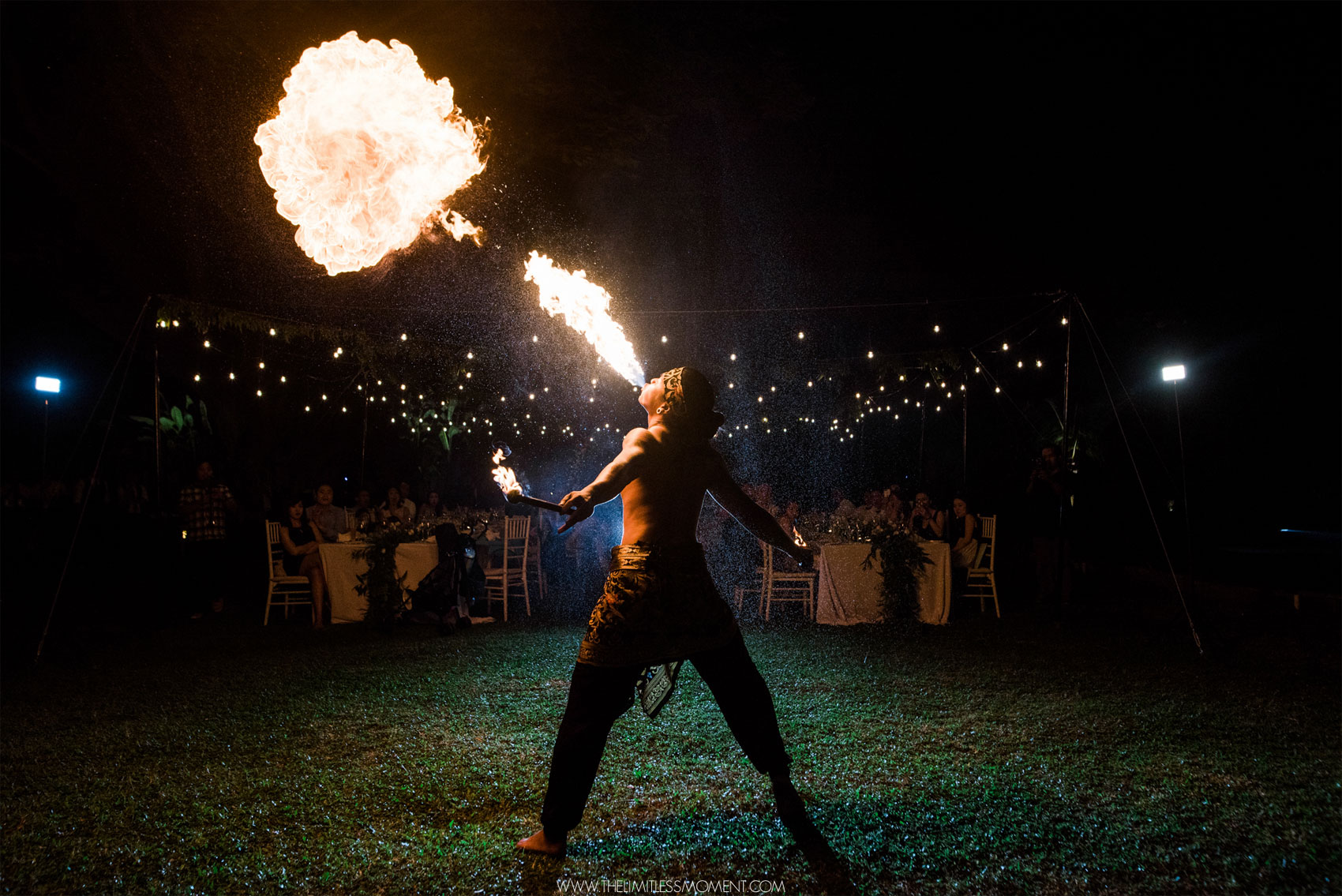 Dramatic Balinese fire breathing performance during an evening wedding reception at Astagina Resort.