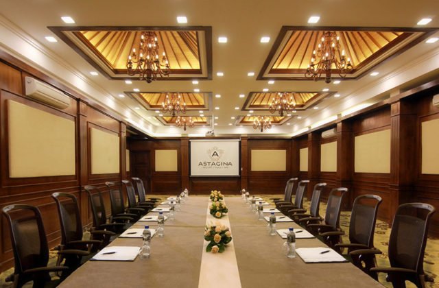 Executive boardroom setup featuring a large conference table for business meetings at Astagina Resort.