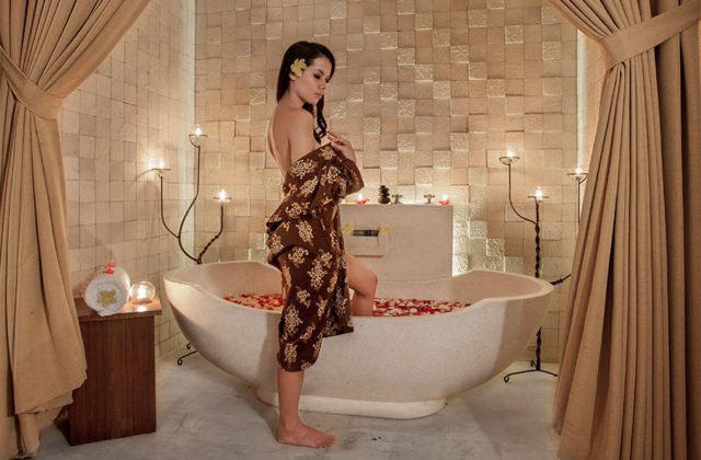 Guest enjoying a luxurious and relaxing flower bath experience inside the villa at Astagina Resort.