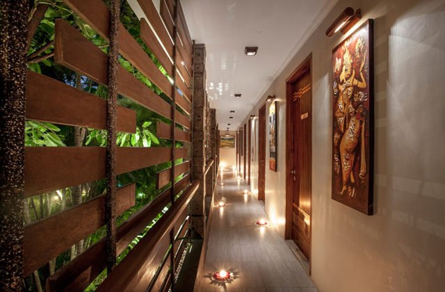Cozy evening ambiance on the private room terrace featuring warm lighting at Astagina Resort Bali.