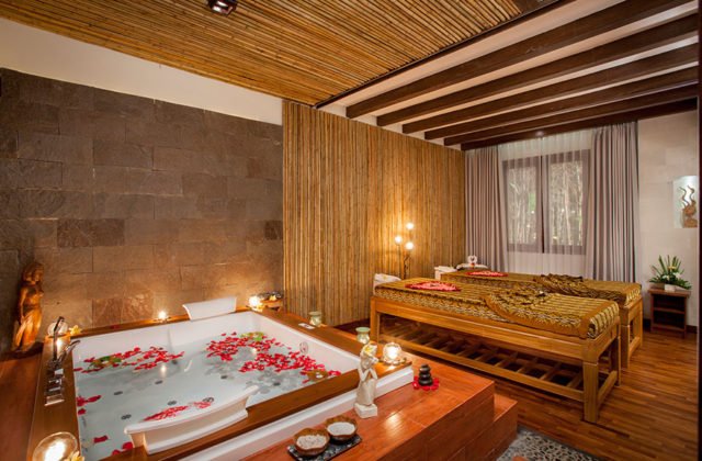 Romantic spa bathtub setup decorated with fresh flower petals ready for guests at Astagina Resort.