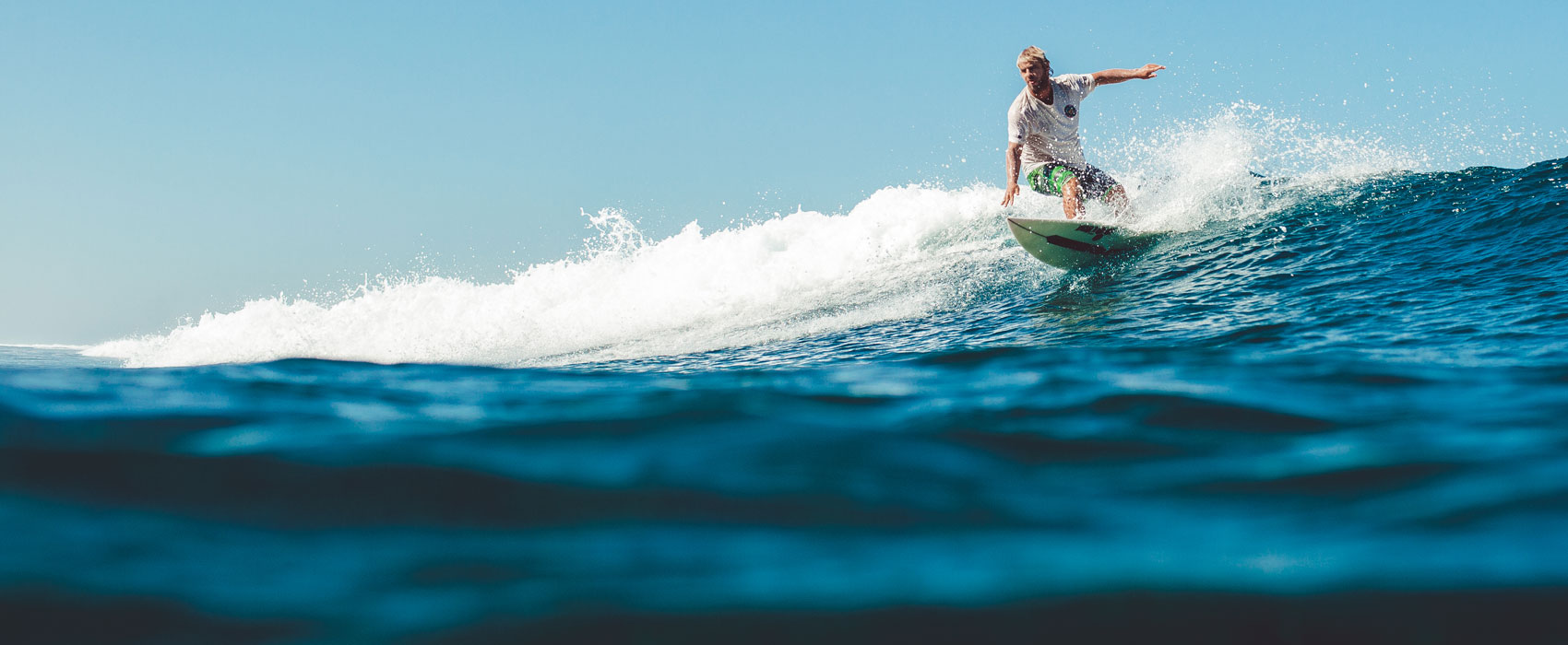 Surfer riding the waves near Astagina Resort Bali.
