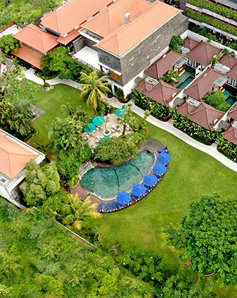 Aerial view of the lush central garden and swimming pool at Astagina Resort.