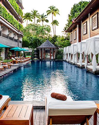 Luxury main swimming pool at Astagina Resort with sun loungers and cabanas.