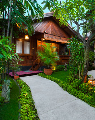 Exterior of a one-bedroom garden villa at Astagina Resort with lush tropical landscaping.