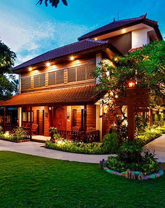 Evening view of a spacious private villa surrounded by tropical gardens at Astagina Resort