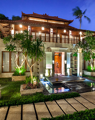 Front entrance of a luxury 3-bedroom pool villa at Astagina Resort at night.