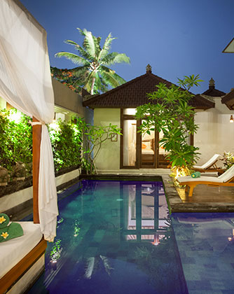 Luxury private pool at Astagina Resort's two-bedroom villa at night.