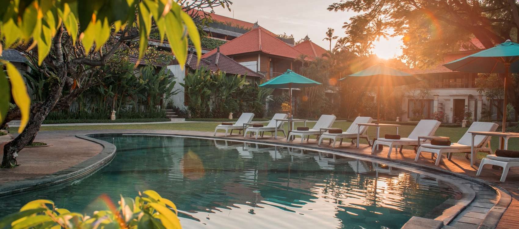 Spacious family-friendly swimming pool at Astagina Resort Bali surrounded by tropical gardens