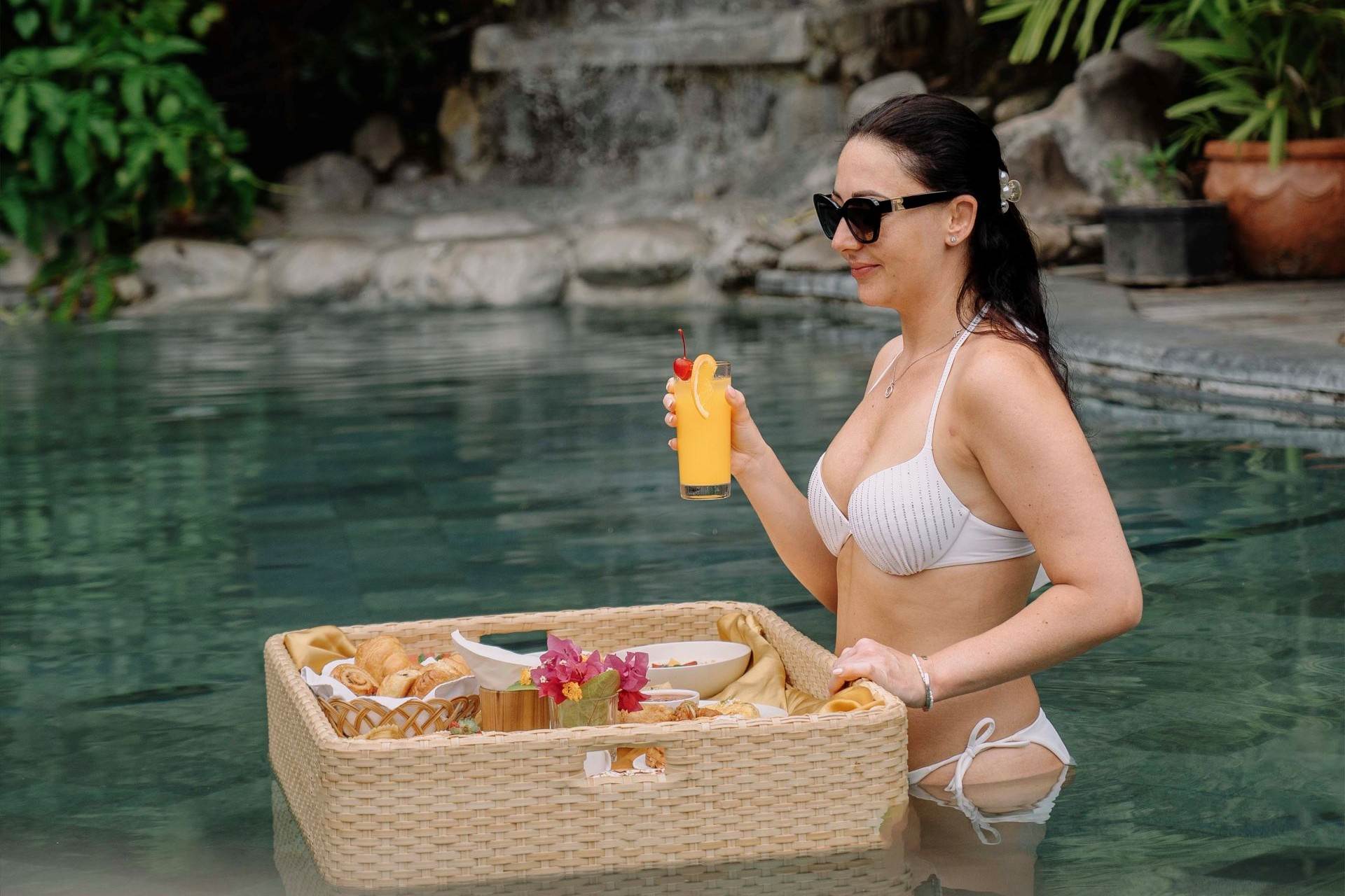 Luxury floating breakfast dining experience in the swimming pool at Astagina Resort Villa Bali.