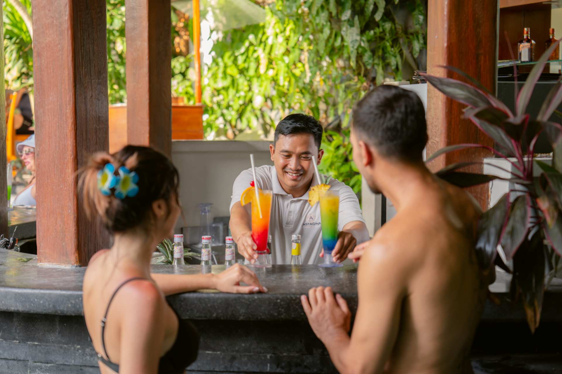 Enjoying refreshing drinks during happy hour at Astagina Resort Legian Bali