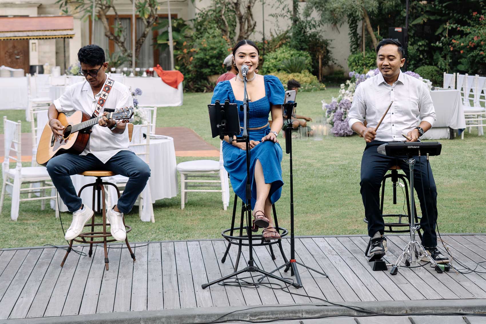 Acoustic live band performing at an outdoor wedding reception in Astagina Resort.