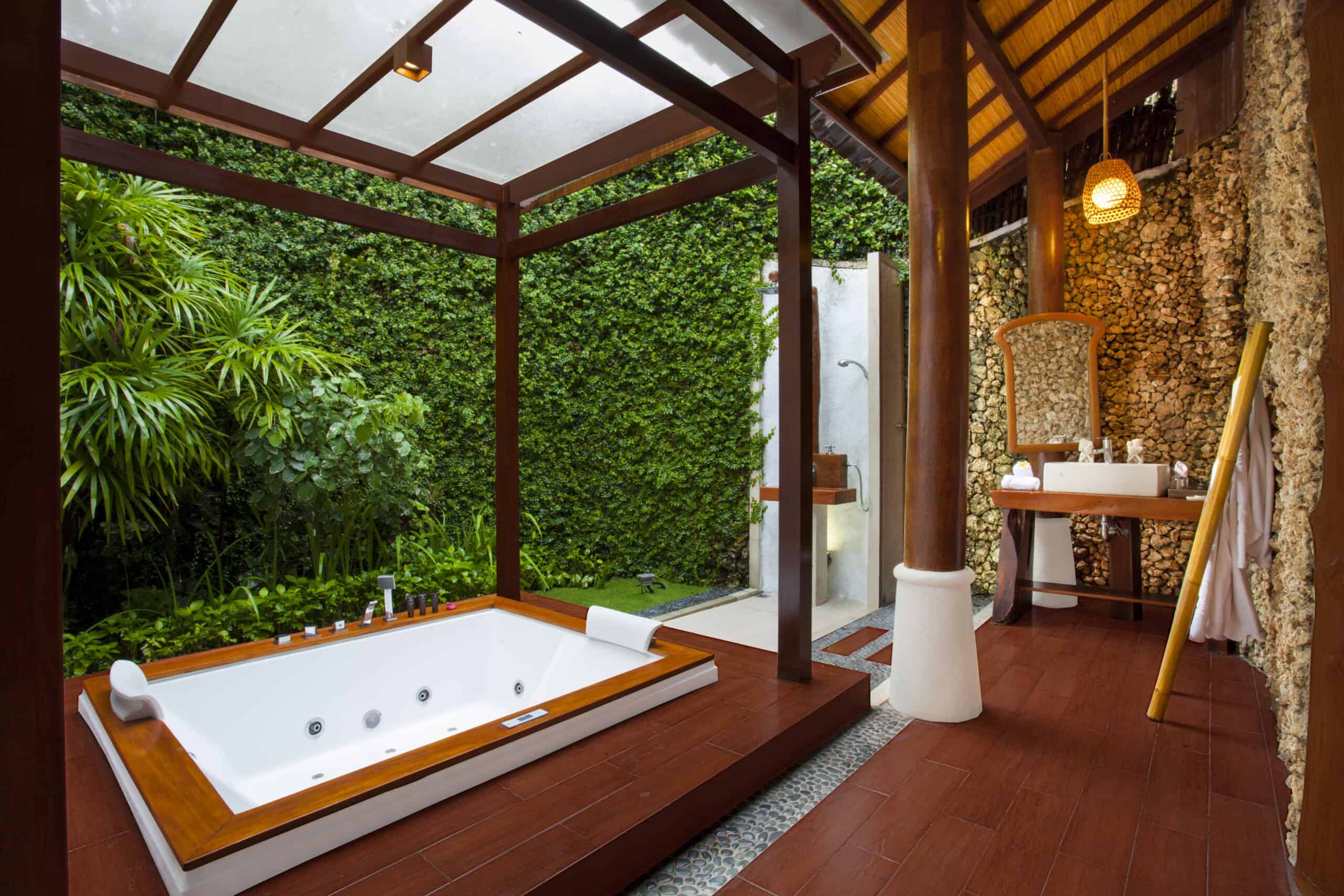 Open-air villa bathroom with jacuzzi and natural stone design