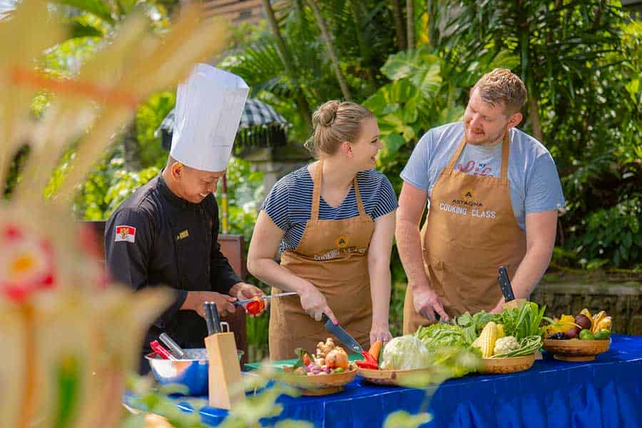 Outdoor cooking lesson at Astagina Resort featuring fresh local ingredients and vegetables.