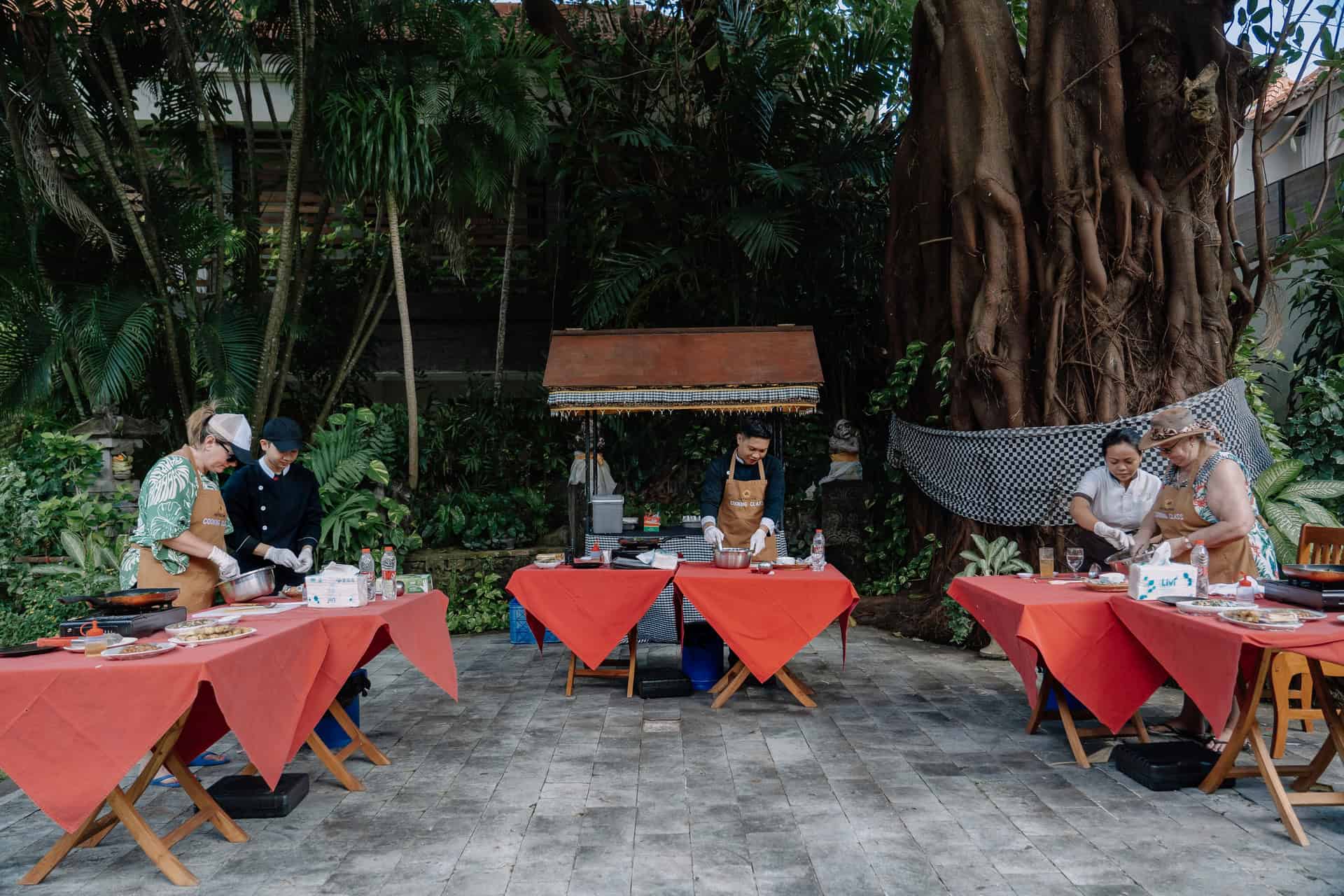 Outdoor cooking lesson at Astagina Resort featuring fresh local ingredients and vegetables.