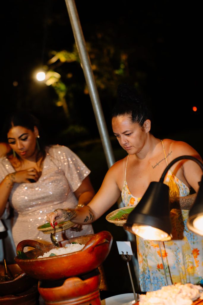 A guest serving herself during the authentic Balinese Suckling Pig BBQ dinner experience at Astagina Resort in Legian.