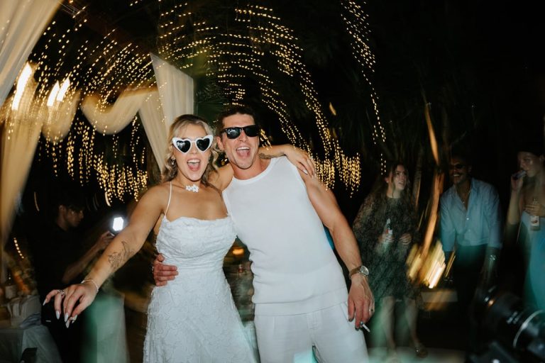 Happy couple celebrating under fairy lights at a Bali garden wedding venue reception at Astagina Resort Legian