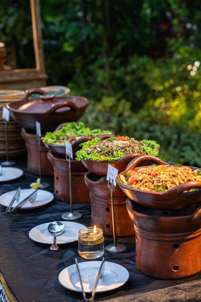 Authentic Balinese dishes including Ayam Betutu served in traditional clay pots at Pangi Bistro Legian