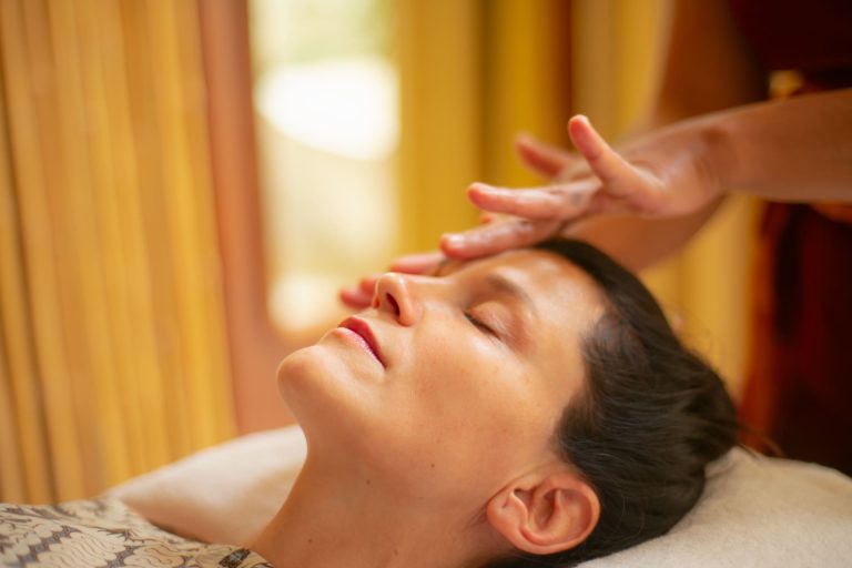 Professional therapist delivering a soothing facial treatment for after-sun skin recovery at Anjali Spa in Legian Beach Resort Bali