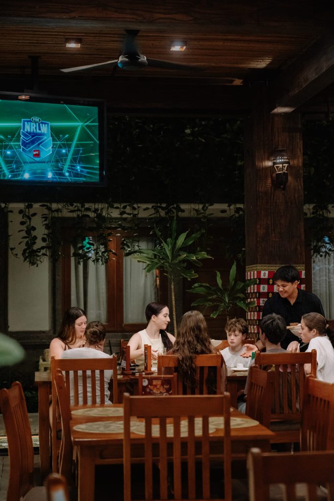 Family enjoying kid-friendly BBQ buffet dinner at Pangi Bistro, Astagina Resort Legian, with staff serving guests
