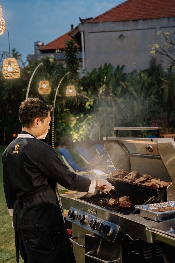 Chef grilling Wagyu beef and sausages at the poolside BBQ station during Tuesday's Aussie BBQ Buffet, Astagina Resort Legian